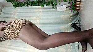watch her dance seductively in sheer pantyhose and sky-high heels showing off those long legs