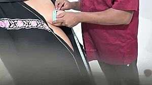 Doctor examines hijab lady patient closely in hospital room