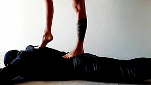Dominatrix nika tramples slave's belly feet pressing stomach hard