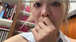 Asian girl masturbates in library next to reader