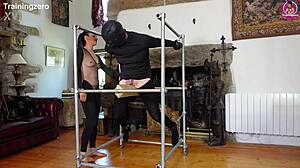 Intense whipping on wooden bondage frame