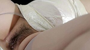 Asian girl in stockings oils her hairy pussy