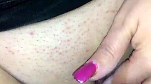 Face mask hides mouth during black dildo play