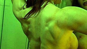 Busty ginger bodybuilder flexes huge muscles and tits in mirror