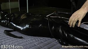 Exploring intense bondage and sadomasochism with tight restraints and control.