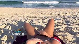Bent over doggystyle ass masturbation on brazilian beach, vendor watching
