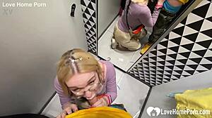 gf sneaks a quick blowjob in changing booth with tattooed guy. cum in mouth seals the deal.