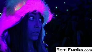 Romi Rain and Dani dive into steamy lesbian fun under black-light vibes.