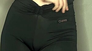 She teases with a close-up cameltoe in tight black leggings.