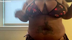 Hazelnutxxx smears her ebony face with cum in a bikini