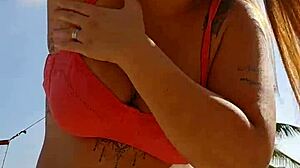 African woman flashing on the beach