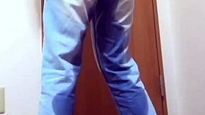 A girl wets her jeans while waiting for the bathroom her brother is using