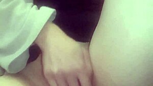 Amateur massages her hot wet pussy with big tits exposed.