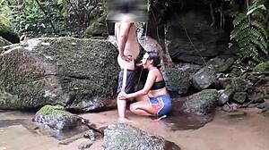 Ebony woman enjoys a voyeuristic encounter with blowjob and anal in the waterfall