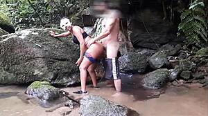 Ebony woman enjoys a voyeuristic encounter with blowjob and anal in the waterfall