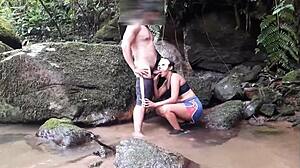 Ebony woman enjoys a voyeuristic encounter with blowjob and anal in the waterfall