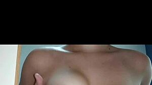 A hot Latina teen sensualizes in front of the mirror, showing off her big tits and ass.