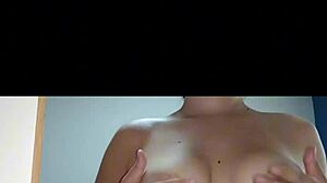 A hot Latina teen sensualizes in front of the mirror, showing off her big tits and ass.