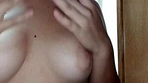 A hot Latina teen sensualizes in front of the mirror, showing off her big tits and ass.