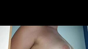 A hot Latina teen sensualizes in front of the mirror, showing off her big tits and ass.