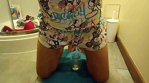 Sexy girl wets herself while masturbating in the toilet