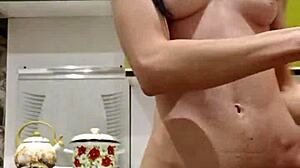 Raven-haired petite woman uses toys in the kitchen