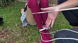Caressing dirty socks on bound blonde outdoors.