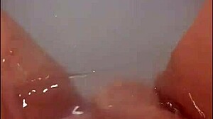 a pretty wife with long hair masturbates in jacuzzi bath, ending with bright cumshot