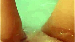 a pretty wife with long hair masturbates in jacuzzi bath, ending with bright cumshot