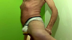 male pelvic floor stretching and restore on stool in striped briefs