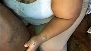 Enjoying a smoked sausage at a casual gathering.