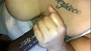 Enjoying a smoked sausage at a casual gathering.