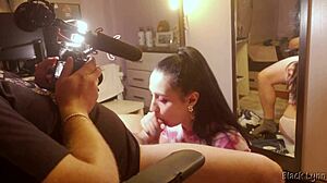 Behind the scenes, stunning brunette teen Black Lynn gives a huge blowjob with handjob and swallows mouthful