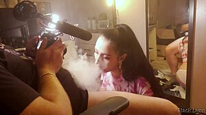 Behind the scenes, stunning brunette teen Black Lynn gives a huge blowjob with handjob and swallows mouthful