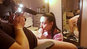 Behind the scenes, stunning brunette teen Black Lynn gives a huge blowjob with handjob and swallows mouthful