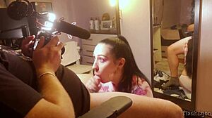 Behind the scenes, stunning brunette teen Black Lynn gives a huge blowjob with handjob and swallows mouthful