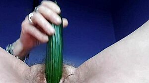granny casually plays with her hairy german pussy using a cucumber in the kitchen