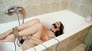 beautiful woman is bound in tight bondage ropes by the swimming pool.