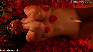 Danish beauty Denise Klarskov enjoys a romantic moment with red roses in Scandinavian setting