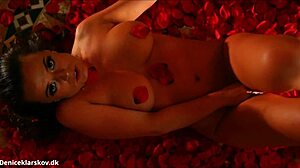 Danish beauty Denise Klarskov enjoys a romantic moment with red roses in Scandinavian setting