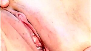 Hot mature woman shows her shaved pussy in a close up homemade video. She fingers her natural tits gently