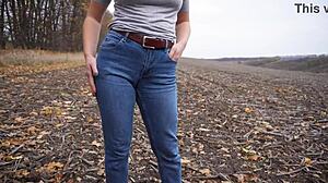 The milf teases her big cameltoe in tight blue jeans outdoors