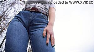 The milf teases her big cameltoe in tight blue jeans outdoors