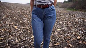 The milf teases her big cameltoe in tight blue jeans outdoors