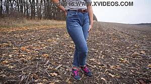 The milf teases her big cameltoe in tight blue jeans outdoors