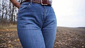 The milf teases her big cameltoe in tight blue jeans outdoors