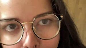 Nerdy brunette girlfriend gives deep blowjob to big cock in shorts, contrasting beauty with passion