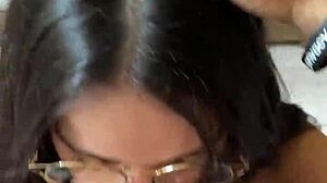 Nerdy brunette girlfriend gives deep blowjob to big cock in shorts, contrasting beauty with passion