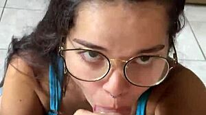 Nerdy brunette girlfriend gives deep blowjob to big cock in shorts, contrasting beauty with passion