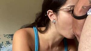 Nerdy brunette girlfriend gives deep blowjob to big cock in shorts, contrasting beauty with passion